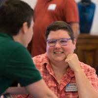 Faculty and staff members laugh together.
